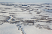 An aerial view of winter tundra with frozen lakes & rivers in the south of the Yamal Peninsula. Western Siberia, Russia