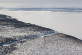 An aerial view of the frozen River Ob near Salekhard in the south of the Yamal Peninsula with the Polar Ural Mountains in the distance. Western Siberia, Russia
