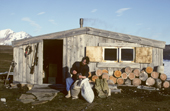 Trapper Louis Nielsen sorts a bag of Eiderdown outside his hut, on the island of Eholmen. Spitsbergen