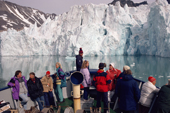 Tourists watch as the ship approaches a glacier in Magdalene Fjord, Spitsbergen